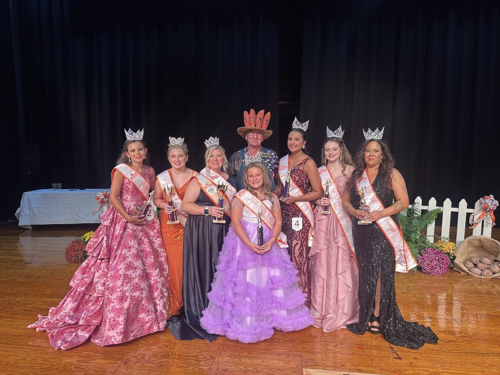 2026-2027 NC Yam Festival queens Young Miss through Mrs. on stage with the Yam Man